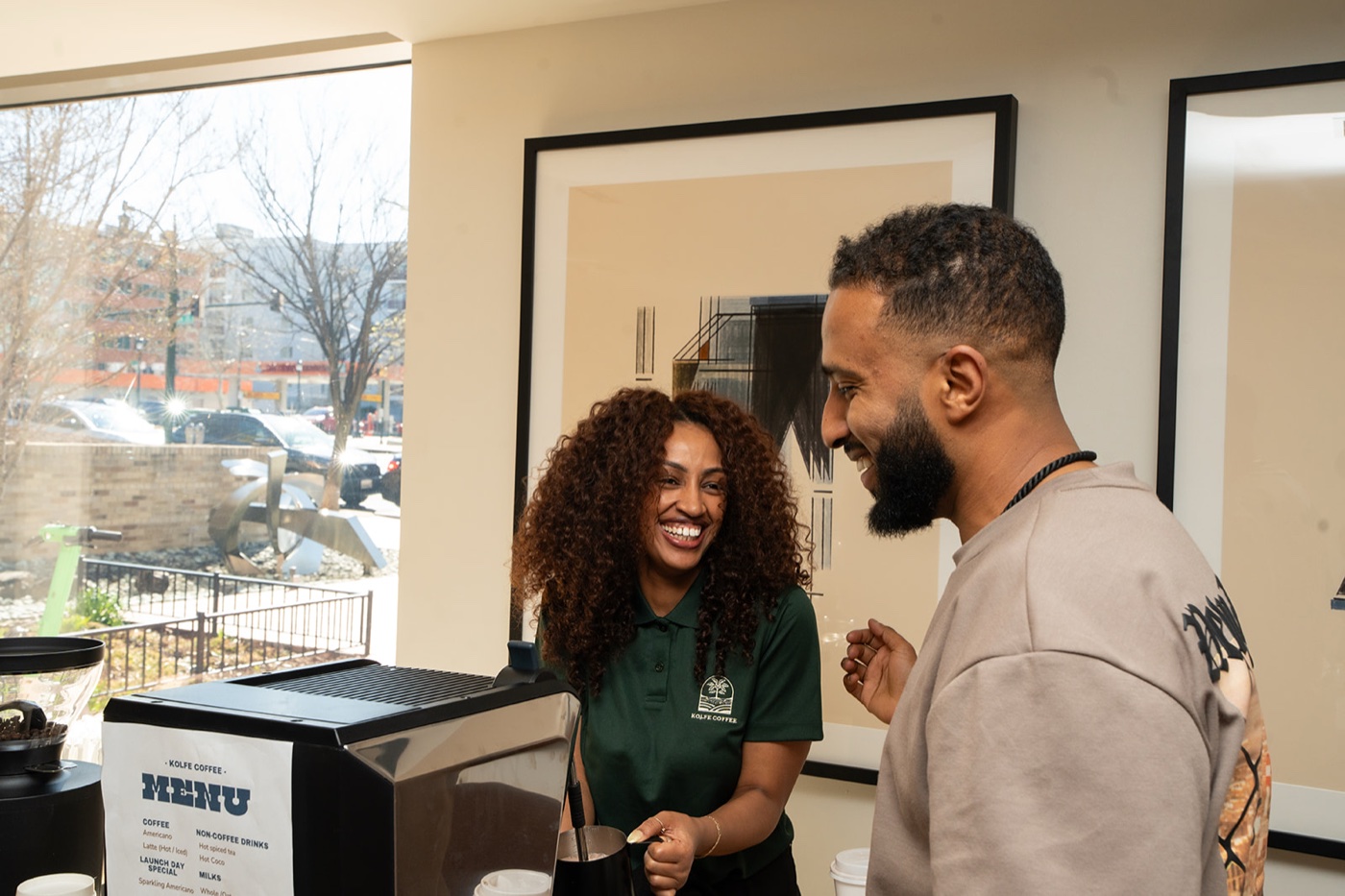Kolfe Coffee barista smiling with a guest